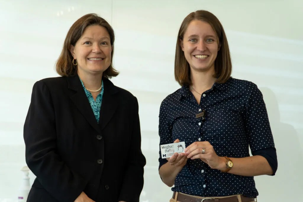 Professor Dawn Tilbury hands Meghan Dailey a gift.