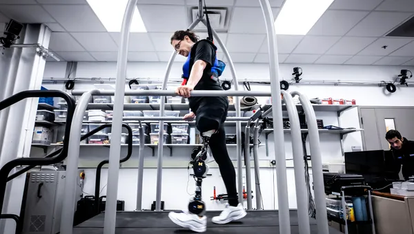 A patient tests an open-source robotic leg on a treadmill.