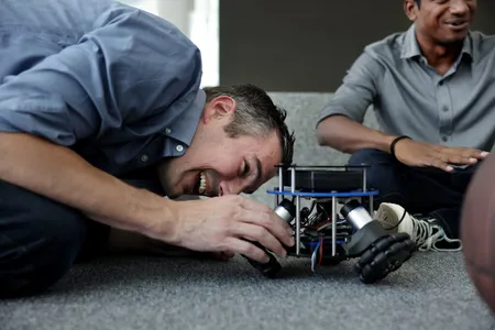 A roboticist presenting to a group of students.