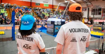 Athena Lieu and a volunteer from Michigan Technological University at a FIRST Robotics Competition in Escanaba, Michigan.