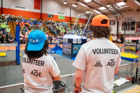 Athena Lieu and a volunteer from Michigan Technological University at a FIRST Robotics Competition in Escanaba, Michigan.