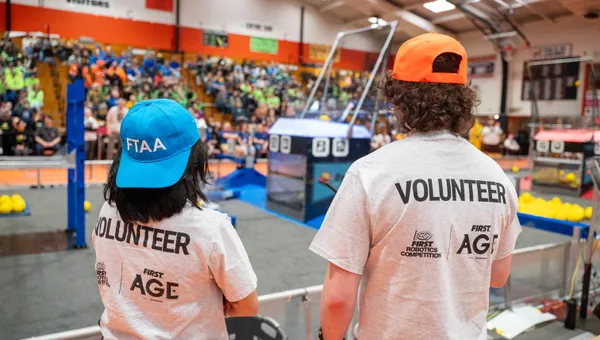 Athena Lieu and a volunteer from Michigan Technological University at a FIRST Robotics Competition in Escanaba, Michigan.