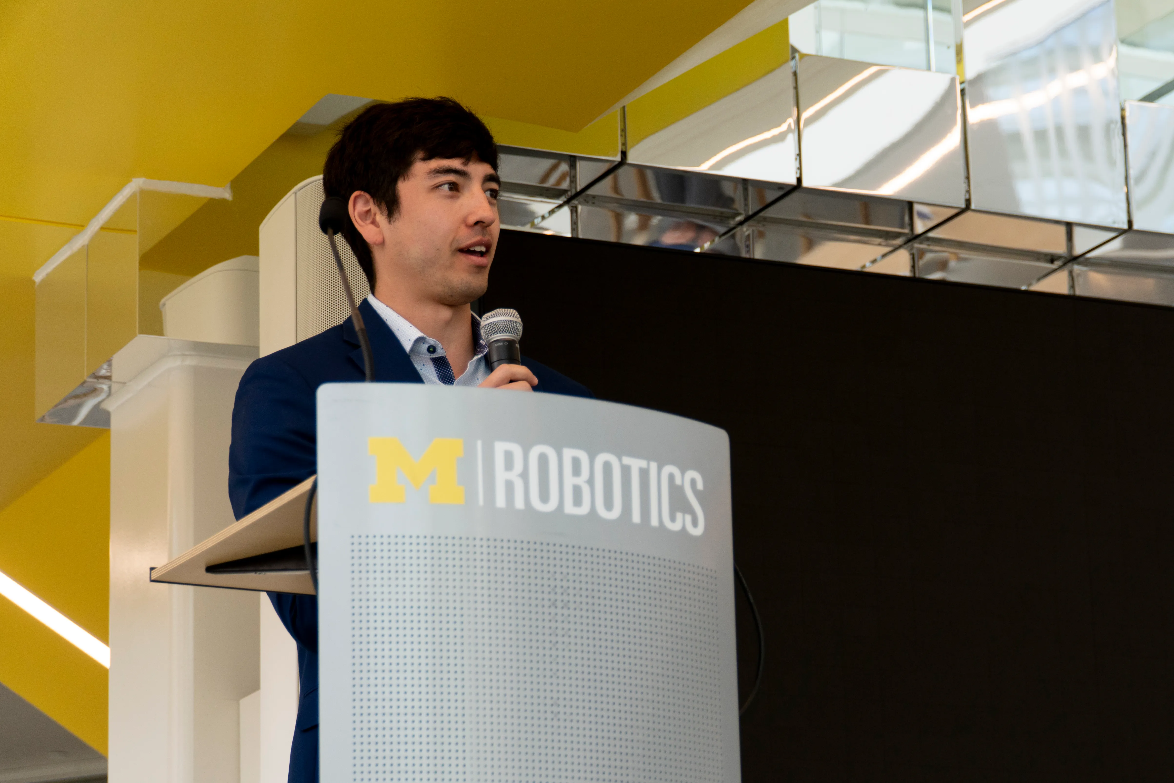 Brandon Apodaca presents at the closing of the first ROBOSYM graduate research symposium