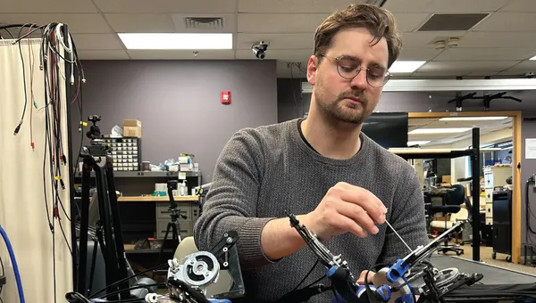 Thomas E Augenstein working with the Hand eMBot, his self-powered robot to improve post-stroke hand function.