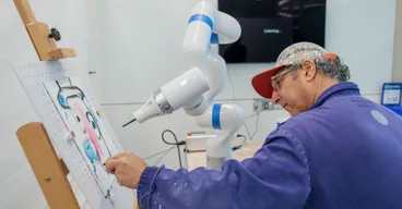 Artist Adnan Charara paints with a robot arm programmed to collaborate on artwork.