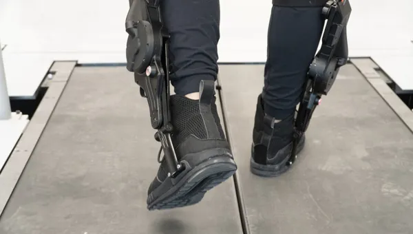 Leo Medrano, a PhD student in the Neurobionics Lab at the University of Michigan, tests out an ankle exoskeleton on a two-track treadmill. Researchers were able to give the exoskeleton user direct control to tune its behavior, allowing them to find the right torque and timing settings for themselves.