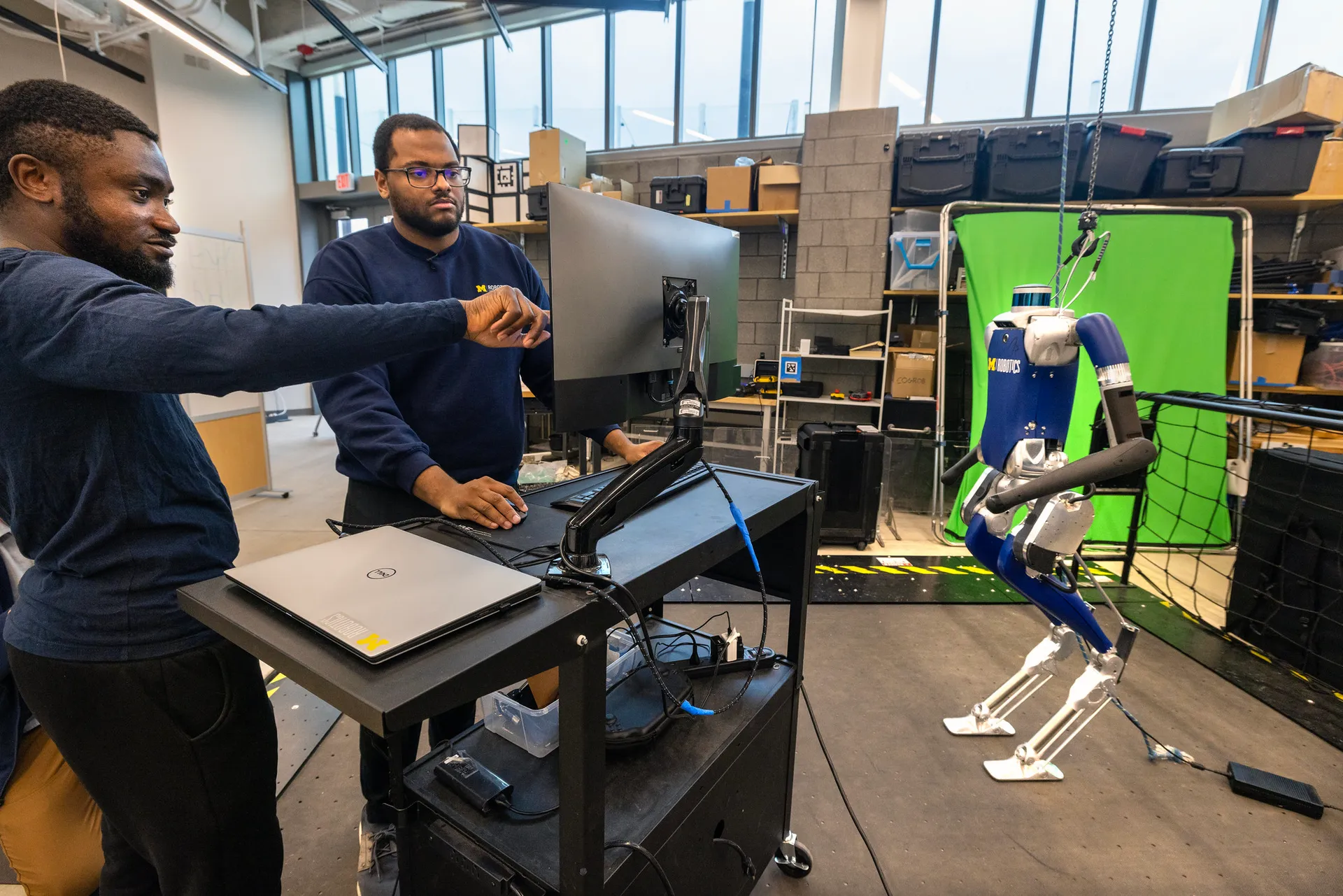 Researchers work on a state-of-the-art bipedal robot in the Walking Robotics Lab.