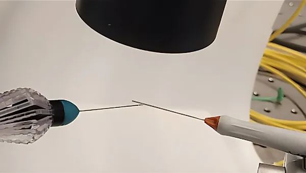 Surgical instruments are held under a lens in a lab setting to test enhanced imaging.