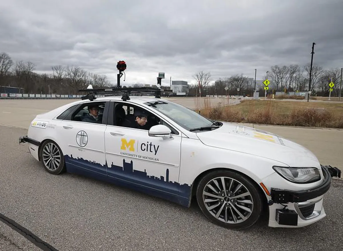 An autonomous vehicles drives around Mcity
