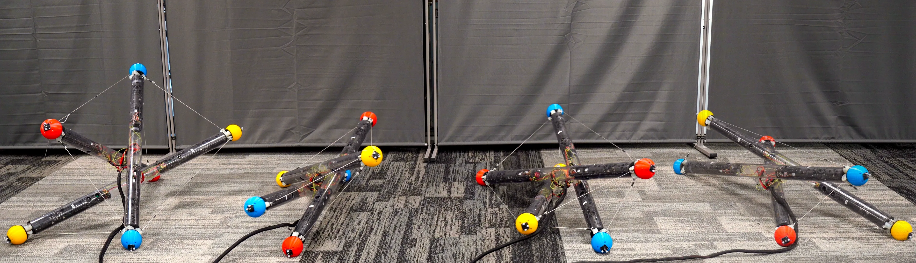 A robot made of three tubes and cables connecting them tumbles across the floor in different arrangements in this composite image.